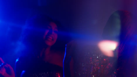Close-Up-Of-Two-Women-In-Nightclub-Bar-Or-Disco-Dancing-With-Sparkling-Lights-4